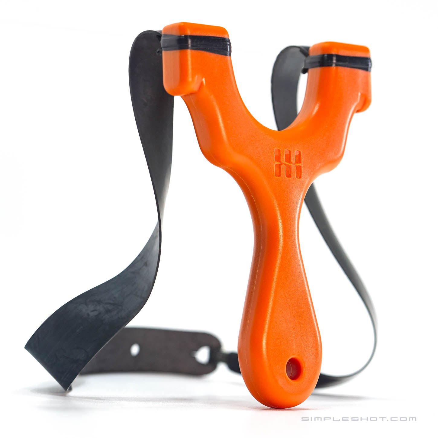 The Axiom Champ is an orange slingshot crafted from plastic and features a black elastic band. Ideal for slingshot enthusiasts, it boasts a compact design with a handle that has a hole at the bottom and bands secured in a forked design at the top. The background is plain white.